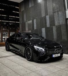 a black car parked in front of a building