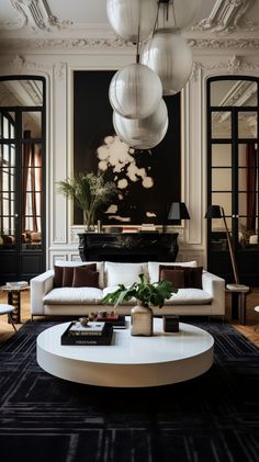 a living room filled with lots of furniture and large white balls hanging from the ceiling