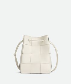 The Bottega Veneta Small Crossbody Bucket Bag combines contemporary style with practicality. Crafted with meticulous attention to detail, this bag features a sleek silhouette that's both modern and timeless. The compact size makes it perfect for carrying essentials, while the crossbody strap ensures hands-free convenience. With its versatile design and luxurious craftsmanship, the Bottega Veneta Small Crossbody Bucket Bag effortlessly elevates any ensemble, whether for daily errands or special occasions. Perfect for the fashion-forward individual seeking both style and functionality, this bag is a statement accessory that exudes understated elegance. Bottega Veneta Cassette, Small Buckets, Accessories Gold, Small Crosses, Metal Accessories, Small Crossbody, Color Code, Lambskin Leather, Luxury Brand