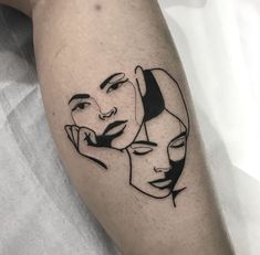 a woman's face with two faces drawn on her arm and behind her leg