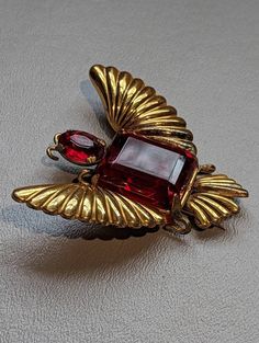 "1940s Sterling Silver Red Rhinestone Bug Butterfly Fur Clip HALLMARKS Sterling on clip mechanism. MEASUREMENTS 2 1/2\" x 2 5/16\" WEIGHT 24.26 Grams.               MATERIALS Sterling Silver, Glass and Gold Vermeil. CONDITION In very good to excellent condition, please use all pictures as part of item's description. Spectacular 1940s era Sterling Silver fur clip featuring a bug or butterfly design. Clip has large Emerald cut red glass stone and smaller oval cut stone as the head.  The stone that Antique Red Brooch For Formal Occasions, Vintage Red Brooches For Formal Occasions, Vintage Red Jewelry For Evening, Vintage Ruby Evening Jewelry, Jewelry Holders, Jewelry Boards, Red Rhinestone, Vermeil Jewelry, Butterfly Design