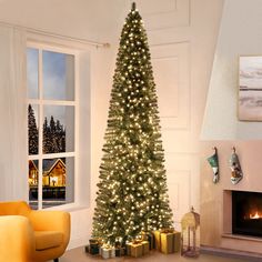 a living room with a lit christmas tree in the corner