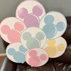 a bunch of balloons sitting on top of a brown chair