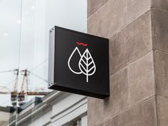 a black and white sign on the side of a building with a crane in the background