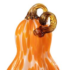 an orange and white glass pumpkin shaped object on a white background with the top part of it's head sticking out