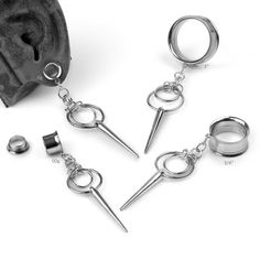 three pairs of metal handcuffs with spikes attached to them