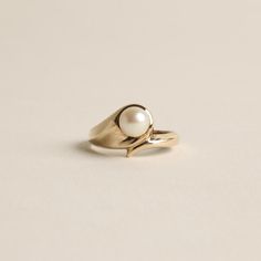 R I N G WITH WHITE PEARL ∙  ∙ SCROUPLES * Details: Solid Gold ∙ 8K Gold ∙ Yellow Gold * Stones: white pearl * Brand: Scrouples * Weight: 2.2 grams * Ring size: 5¼ * Condition: All our pieces are vintage, antique or close to new. The piece undergoes a restoration proces, which includes ultrasonic cleaning and mild polish techniques to enhance the condition of the piece. * All our pieces are vintage and handpicked. We put a lot of effort into finding the most unique and beautiful items for you guy Timeless White Pearl Ring In 14k Gold, Classic Everyday Pearl Drop Ring, Classic Everyday Pearl Ring, Everyday Classic Pearl Drop Ring, White Solitaire Pearl Ring In 14k Gold, Formal White 14k Gold Pearl Ring, White Oval Pearl Ring In 14k Gold, Minimalist White Akoya Pearl Ring, Minimalist White Pearl Ring In 14k Gold