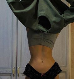 a woman's stomach is shown with an open hoodie over her top and bottom