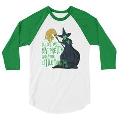 a green and white baseball shirt with an image of a witch on it