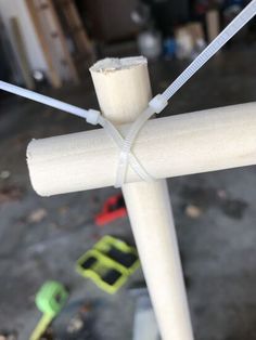 a close up of a wooden pole with wires attached to it and some tools in the background