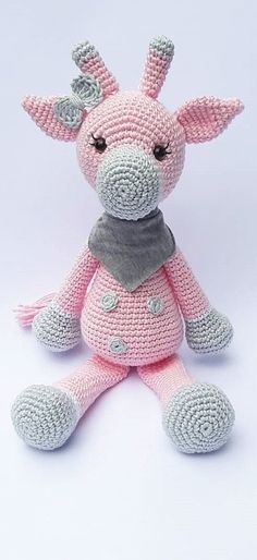 a crocheted giraffe stuffed animal wearing a scarf