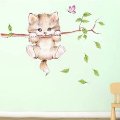 a cat hanging from a branch with leaves on it's back wall decal