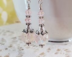 Beautiful iridescent pink crystal earrings are sure to look fabulous with any outfit, dress them up or wear with your favorite jeans! Made with faceted glass beads and silver accents. Earrings measure 1 inch. Pink Crystal Earrings, Pink Iridescent, Iridescent Crystal, Crystal Dangle Earrings, Outfit Dress, Earrings Pink, Faceted Glass, Silver Accents, Pink Crystal