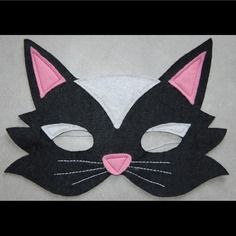 a black cat mask with pink ears and eyes