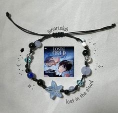 a bracelet with a book and charms on it