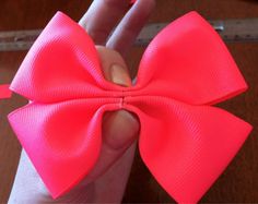 a person holding a pink bow in their hand