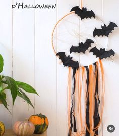 a halloween decoration with bats hanging from it's side