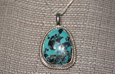 One of a kind, handcrafted, American turquoise and sterling silver pendant. Measures about 48mm X 31mm. Chain not included. Unique Untreated Turquoise Necklace Gift, Unique Untreated Turquoise Necklace As Gift, Unique Untreated Turquoise Necklace For Gift, Blue Engraved Turquoise Pendant Necklace, Blue Turquoise Pendant Necklace With Engraving, Sterling Silver Turquoise Necklace With Large Pendant For Gift, Engraved Turquoise Pendant Necklace, Handmade Sterling Silver Turquoise Teardrop Pendant Necklace, Handmade Turquoise Teardrop Pendant In Sterling Silver