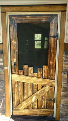 a wooden door with a screen on the front and side panels that are made out of wood