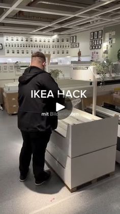 a man standing in front of a desk with boxes on it and the words ikea hack