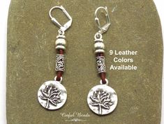 Add a touch of bohemian flair to your jewelry collection with these stunning boho leather dangle earrings! Each pair features a silver plated lotus flower charm, accented by Tibetan style column beads for a unique and eye-catching look. Choose from 9 leather colors to suit your style, and select from 6 different earwire options for a customized fit. These earrings are sure to make a statement and add a touch of boho-chic to any outfit. They make a perfect gift for yourself or a loved one. 𝐋𝐄𝐍𝐆𝐓𝐇: 2 1/4" with lever back earwires. Kidney wires will add about 1". 𝐖𝐈𝐃𝐓𝐇: 5/8" 𝐖𝐄𝐈𝐆𝐇𝐓: Each earring weighs 4.5 grams. A nickel weighs 5 grams. 🔹𝐌𝐀𝐓𝐂𝐇𝐈𝐍𝐆 𝐍𝐄𝐂𝐊𝐋𝐀𝐂𝐄: https://www.etsy.com/listing/1754104720/boho-silver-plated-lotus-flower-leather All jewelry is packaged Bohemian Earrings With Lever Back, Hippie Style Adjustable Nickel-free Earrings, Hippie Nickel-free Adjustable Earrings, Hippie Adjustable Nickel-free Earrings, Cottage Grove, Leather Colors, Boho Leather, Matching Necklaces, Flower Charm