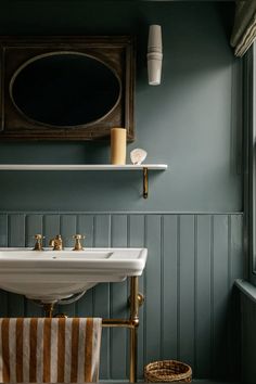 a bathroom sink sitting under a mirror next to a window