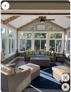 a living room filled with furniture and lots of windows