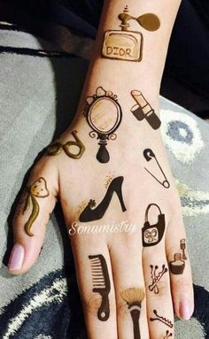 a woman's hand with tattoos on it and various things painted on the palm