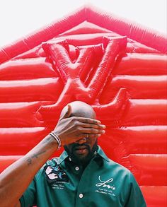 a man holding his head in front of an inflatable wall with the letter y on it