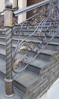 an iron stair railing on the side of a brick building