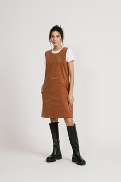 "A cute layering dress, kind of romper-y. It has seams above the bust and at the waist. The skirt has pockets. Wear with the Piper, Blair or last year's Aurora. Tights and boots and done. 97% Cotton / 3% Spandex. Available in Rust Shoulder to hem is 35\" ½\". Model is 5'6\" and wears a size 4. Made in Vancouver, Canada." Casual Fall Pinafore Dress, Casual Corduroy Pinafore Dress For Fall, Casual Corduroy Dresses For Work, Casual Fall Pinafore Dress For Workwear, Casual Cotton Pinafore Dress For Fall, Casual Fall Dresses With Pockets, Casual Knee-length Pinafore Dress For Fall, Knee-length Pinafore Dress With Pockets, Fall Knee-length Mini Dress With Pockets