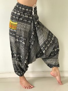 "These super soft rayon baggy unisex harem pants have the \"flow\", perfect of yoga or just a cool strolling. Comfort and character are what these pants are all about. They have the traditional sarong look & feel but a lot more practical when it comes to activity like yoga. As a bonus, they are convertible! Just pull them up and you get yourself a cute jumpsuit in a flash. Together with elastic cuff legs, you can wear them short or long. The pants have smock waist (wide bang elastic) with no Harem Bottoms For Yoga And Festivals, Harem Yoga Bottoms For Festivals, Loose Fit Harem Pants For Yoga And Festivals, Bohemian Harem Yoga Pants With Relaxed Fit, Baggy Hippie Harem Pants For Festival, Bohemian Relaxed Fit Harem Yoga Pants, Traditional Harem Pants For Yoga, Black Hippie Harem Pants For Festival, Relaxed Fit Harem Pants For Yoga