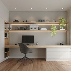 a home office with wooden floors and shelving units on the wall, along with a computer desk