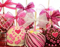 chocolate covered candies with pink bows and hearts on them