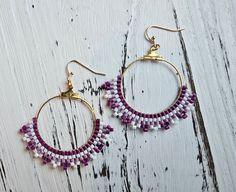 Handmade with miyuki delica seed beads woven around a circle gold earring finding. Purple and White miyuki seed beads make this a beautiful pair of earrings for any occasion. Seed Bead Earring, Bead Earring, Seed Beading, Beaded Hoop Earrings, Gold Earring, Seed Bead Earrings, Purple And White, Earring Findings, Bead Weaving