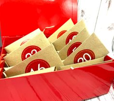 red box filled with brown envelopes sitting on top of a table