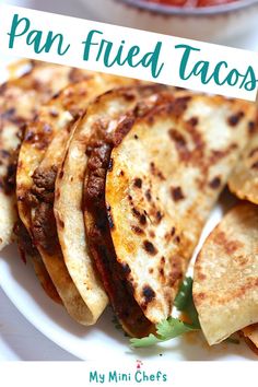 a plate with some tacos on it and a sign that says pan fried tacos