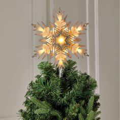 a christmas tree topper with lights on it's branches and snowflakes