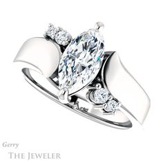 a white gold ring with a pear shaped diamond