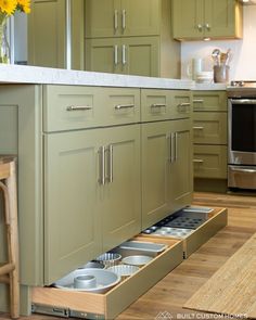 an open drawer in the middle of a kitchen