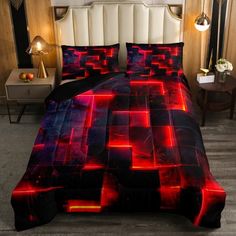 a bed covered in a red and black comforter next to a night stand with two lamps