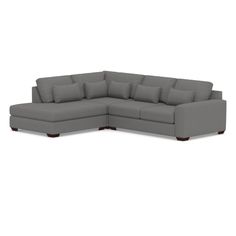 a gray sectional couch with pillows on it