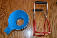 a pair of scissors and a measuring cup on a wooden table