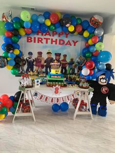 an image of a birthday party with balloons and decorations on the table in front of it