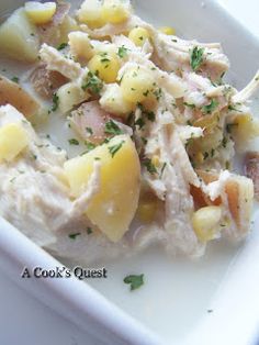 a white bowl filled with food and garnished with parsley