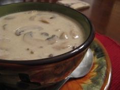 a bowl filled with soup sitting on top of a plate