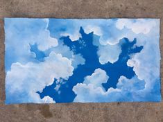 a blue sky with clouds painted on it