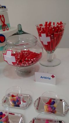 candy and candies are on display in clear bowls with name tags attached to them