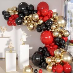 the balloon arch is decorated with black, red and gold balloons