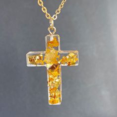 Сross necklace with gold flakes  in resin jewelry . This pendant made with real gold flakes and clear jewelry high-quality resin. Total length of approx: 1 inches Christian cross necklace: https://www.etsy.com/listing/552756206/cross-necklace-real-flowers-jewelry?ref=shop_home_active_61&pro=1&frs=1 https://www.etsy.com/listing/640326800/sross-from-real-flowers-in-resin-baptism?ref=shop_home_active_62&pro=1&frs=1 https://www.etsy.com/listing/654469895/purple-flower-in-resin-cross-necklace?ref=sho